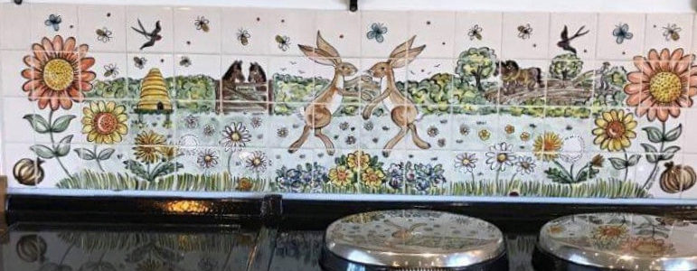 Countryside tile mural behind aga gooker