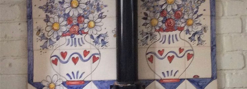Flowers in vases tile mural behind Aga range cooker