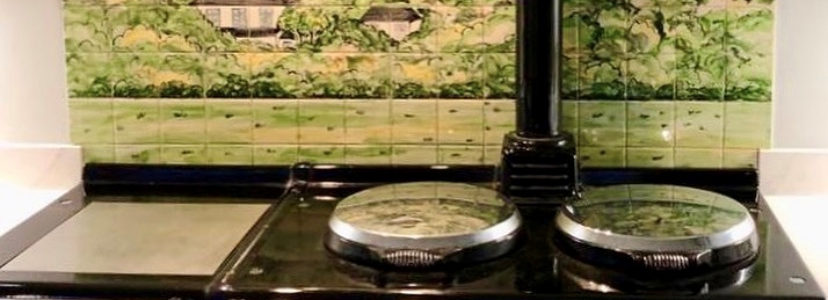 Green wood tile mural behind Aga range cooker