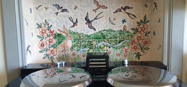 Bird tile mural behind Aga range cooker