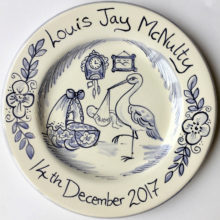 Hand painted blue and white birth celebration plate