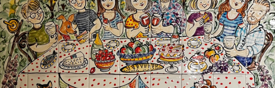 Hand painted tile mural of family having picnic in garden
