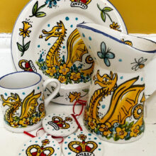 Hand painted pottery featuring golden dragons, daffodils and crowns