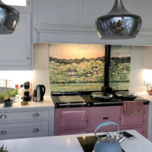 Green wood tile mural behind Aga range cooker in kitchen