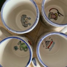 paintings inside mugs