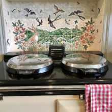 Swallows tile mural behind Aga range cooker