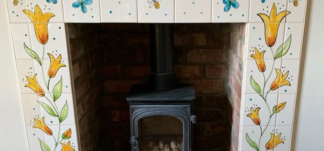Fireplace with flower tile surround